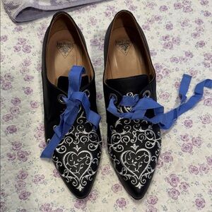 John Fluevog Black Pointed Heels with Silver Heart Embroidery and Blue Ribbon